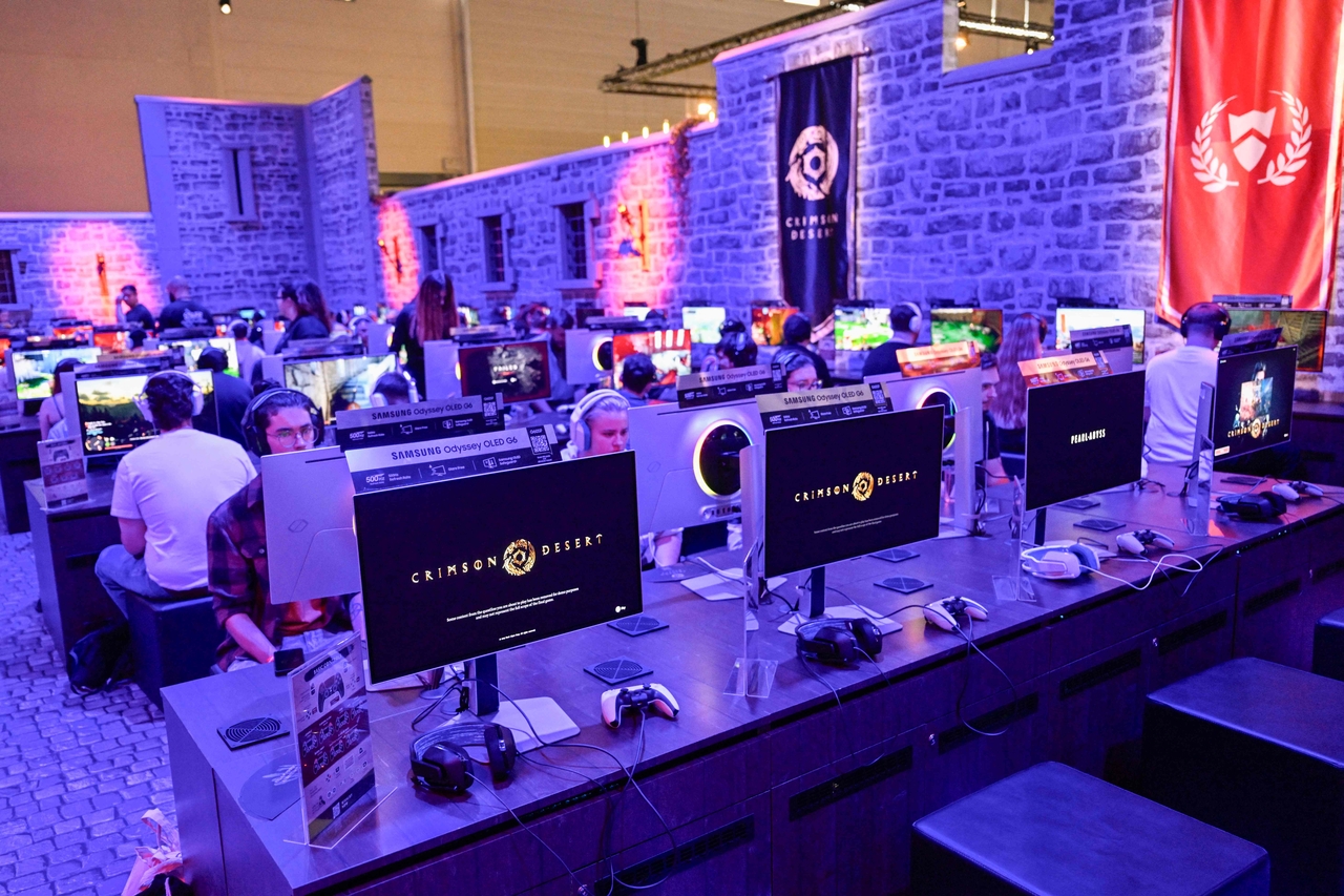 Gaming fans play demo version of Crimson Desert, an upcoming open-world action adventure title developed by Pearl Abyss, at Gamescom 2025 in Cologne, Germany, Thursday. (Yonhap-AFP)