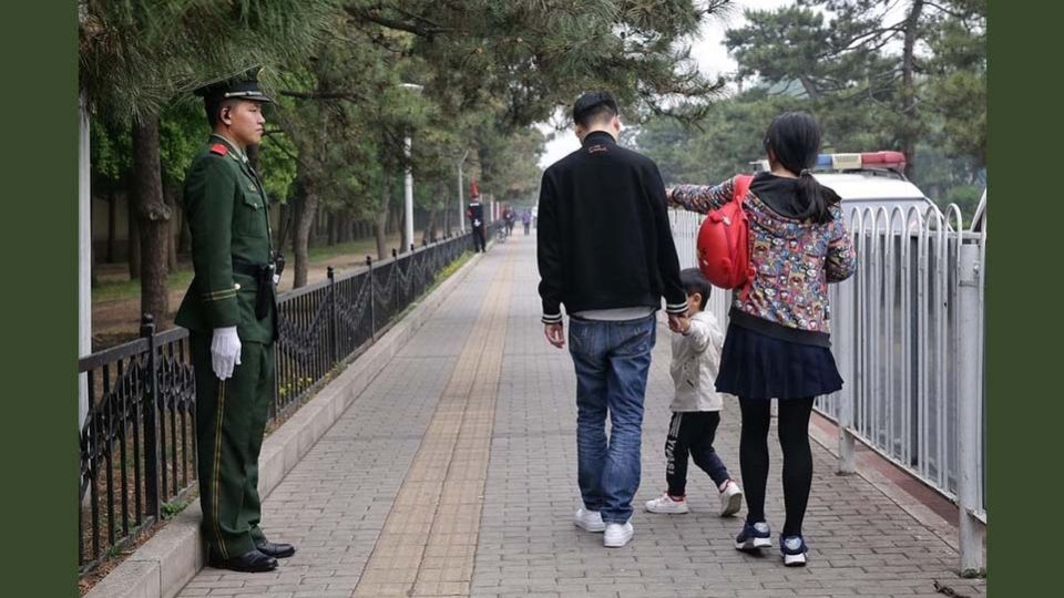 A family walks down a road in Beijing.   (Straits Times)
