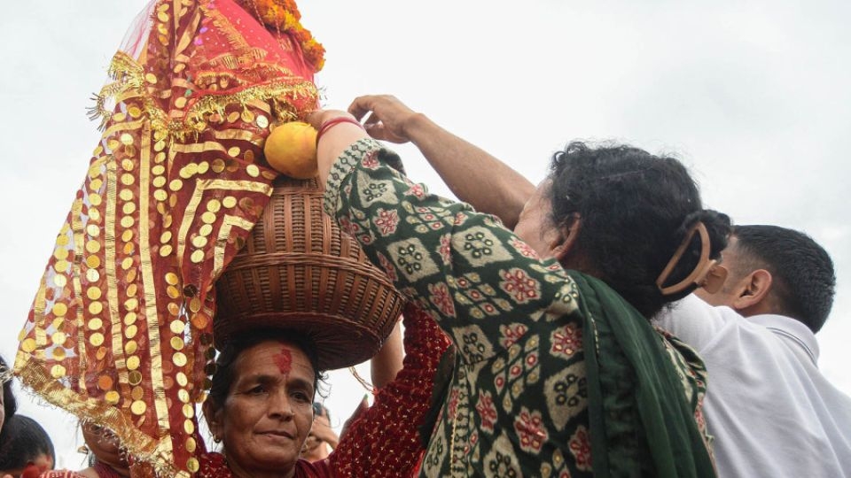 A woman carries the idol of Gaura on her head during the festival.    (Kathmandu Post)
