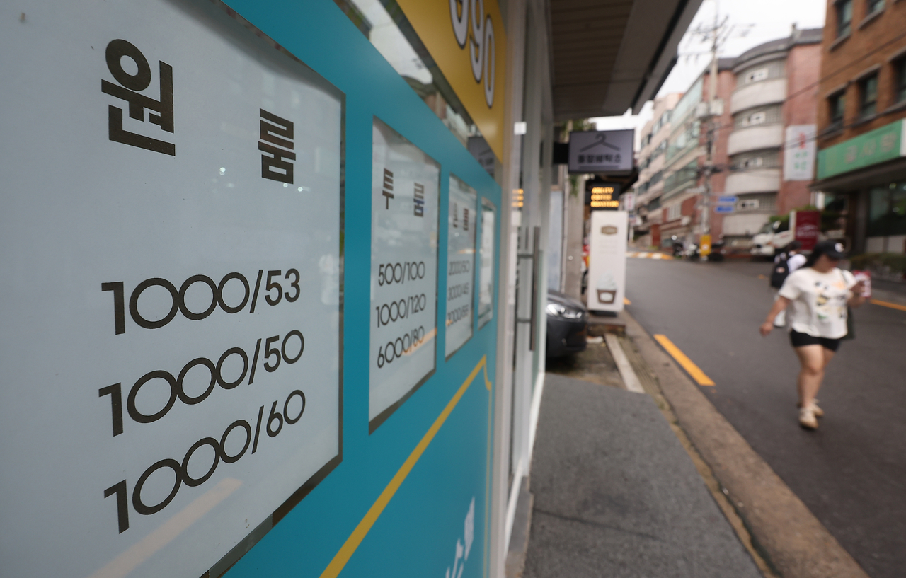 Advertisements for studio units are posted outside of a real estate agent's office in Dongdaemun-gu, Seoul, Tuesday. (Yonhap)