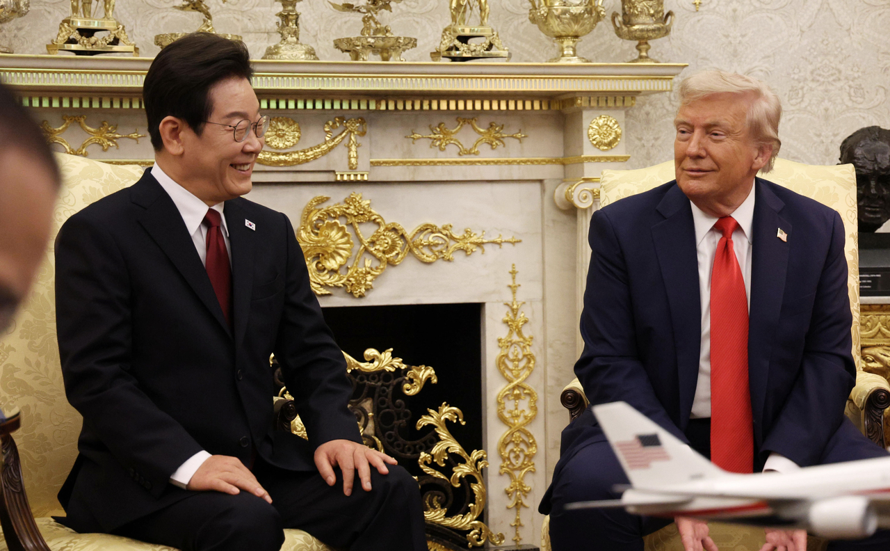 President Lee Jae Myung (left) speaks as he meets US President Donald Trump for a summit at the White House in Washington on Tuesday. (Yonhap)