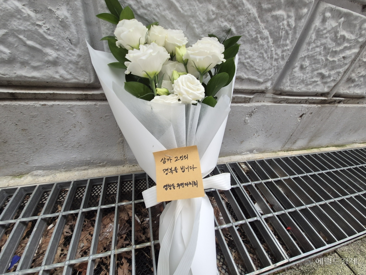 종태 염창동 주민자치회회장이 숨진 모녀를 추모하기 위해 사건 현장에 꽃다발을 뒀다. 김도윤 기자.