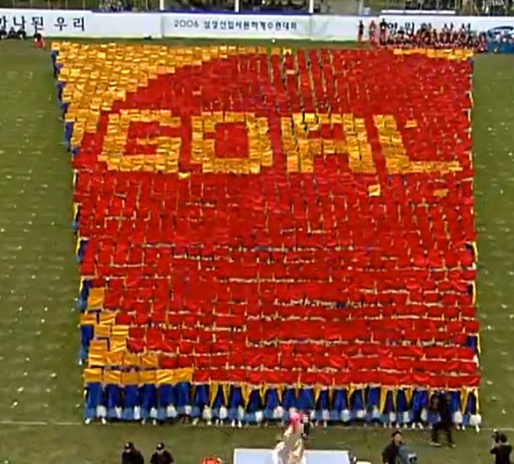 Hundreds of Samsung Electronics new recruits take part in a large-scale cheering performance during the company’s 2006 summer retreat. (YouTube)
