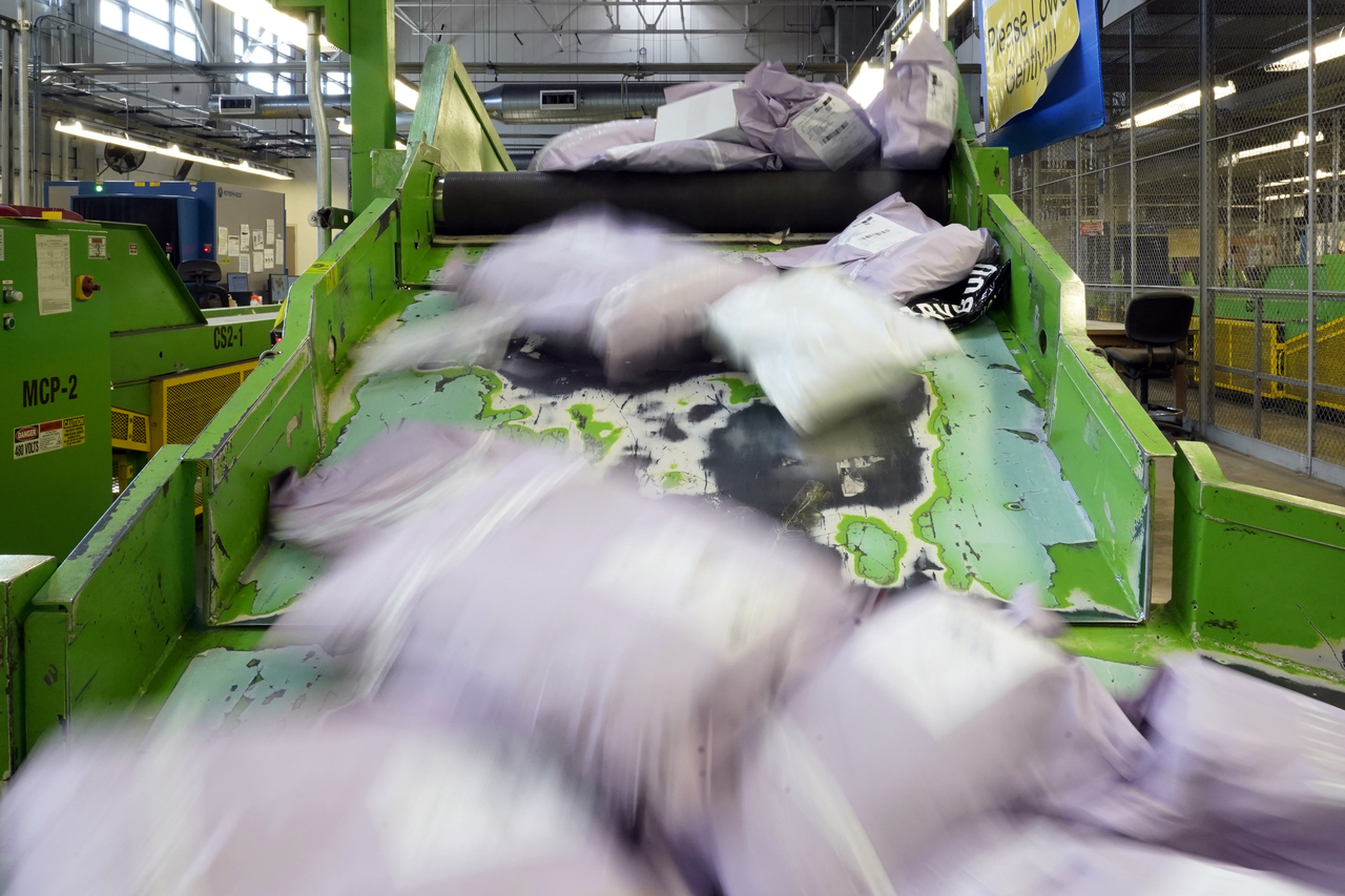 Parcels slide down a ramp after being scanned at the US Customs and Border Protection overseas mail inspection facility at Chicago's O'Hare International Airport in Chicago on Feb. 23, 2024.   AP-Yonhap