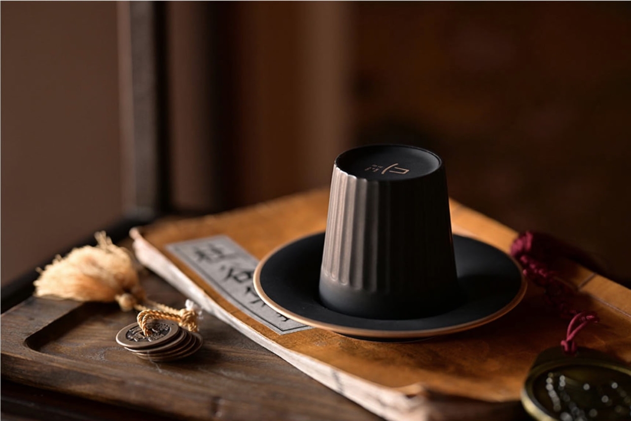 The National Museum of Korea’s ceramic gat mug with gold detail, inspired by the hat once worn by Korean noblemen, is pictured with its matching saucer. The item has quickly sold out online. (National Museum Goods)