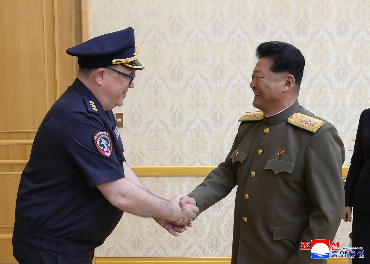 This file photo, published by the Korean Central News Agency, shows North Korea's Minister of Public Security Pang Tu-sop (right) and Russia's Vice Interior Minister Vitaly Shulika (left) shaking hands during their meeting in Pyongyang on May 29, 2025. (Yonhap)