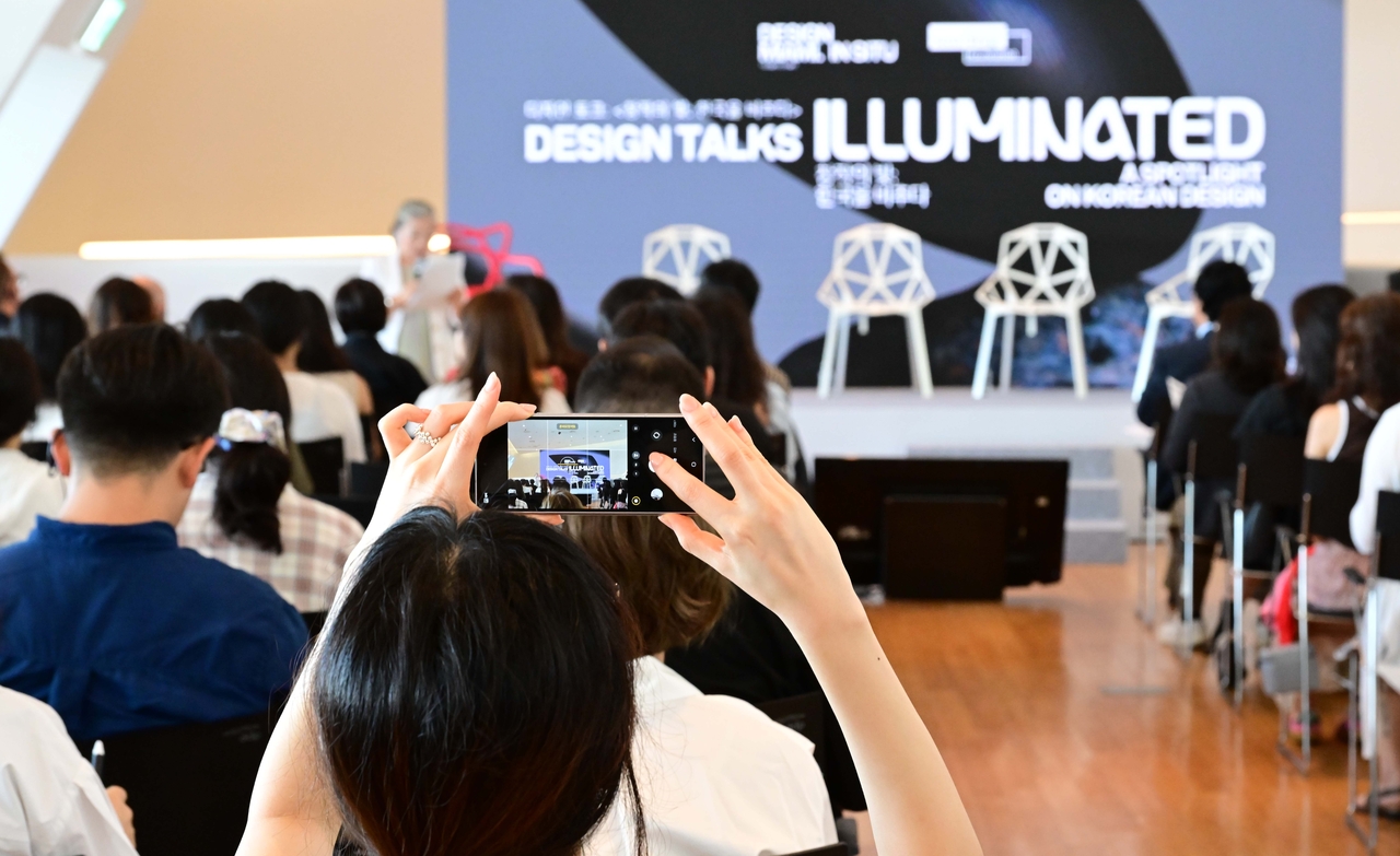 An attendee photographs the venue during Session 1 of Design Talks at Dongdaemun Design Plaza in Seoul, Tuesday. (Lee Sang-sub/The Korea Herald)