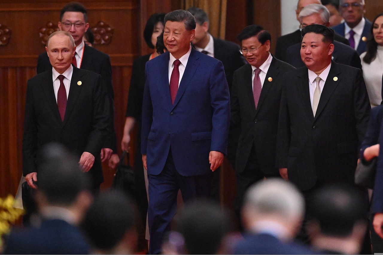 Chinese President Xi Jinping (center), North Korean leader Kim Jong-un (right) and Russian President Vladimir Putin (left) arrive for a reception in the Great Hall of People, following a military parade marking the 80th anniversary of victory over Japan and the end of World War II, in Beijing on Wednesday. (AFP)