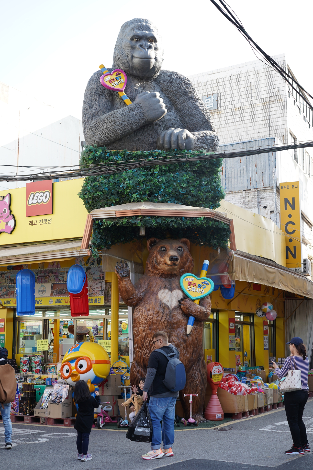 Visitors take photos in front of Seungjin Toy in Jongno, central Seoul. (Lee Si-jin/The Korea Herald)