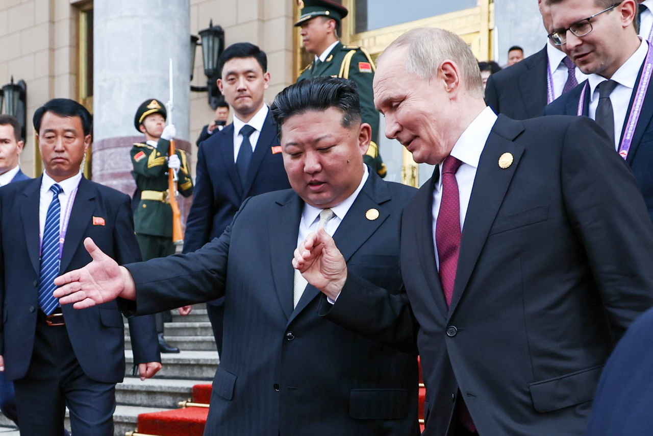 Russian President Vladimir Putin (right) and North Korea's leader Kim Jong-un hold a meeting at the Diaoyutai State Guest House in Beijing. (Pool photo via Tass)
