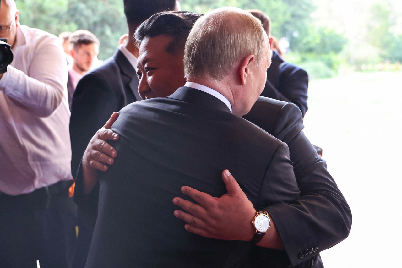 Kim Jong-un (back) is captured wearing what appeared to be an IWC Schaffhausen Portofino Automatic wristwatch, as he embraces Russian President Vladimir Putin following their talks at Beijing’s Diaoyutai State Guesthouse on Wednesday. (Tass-Yonhap)
