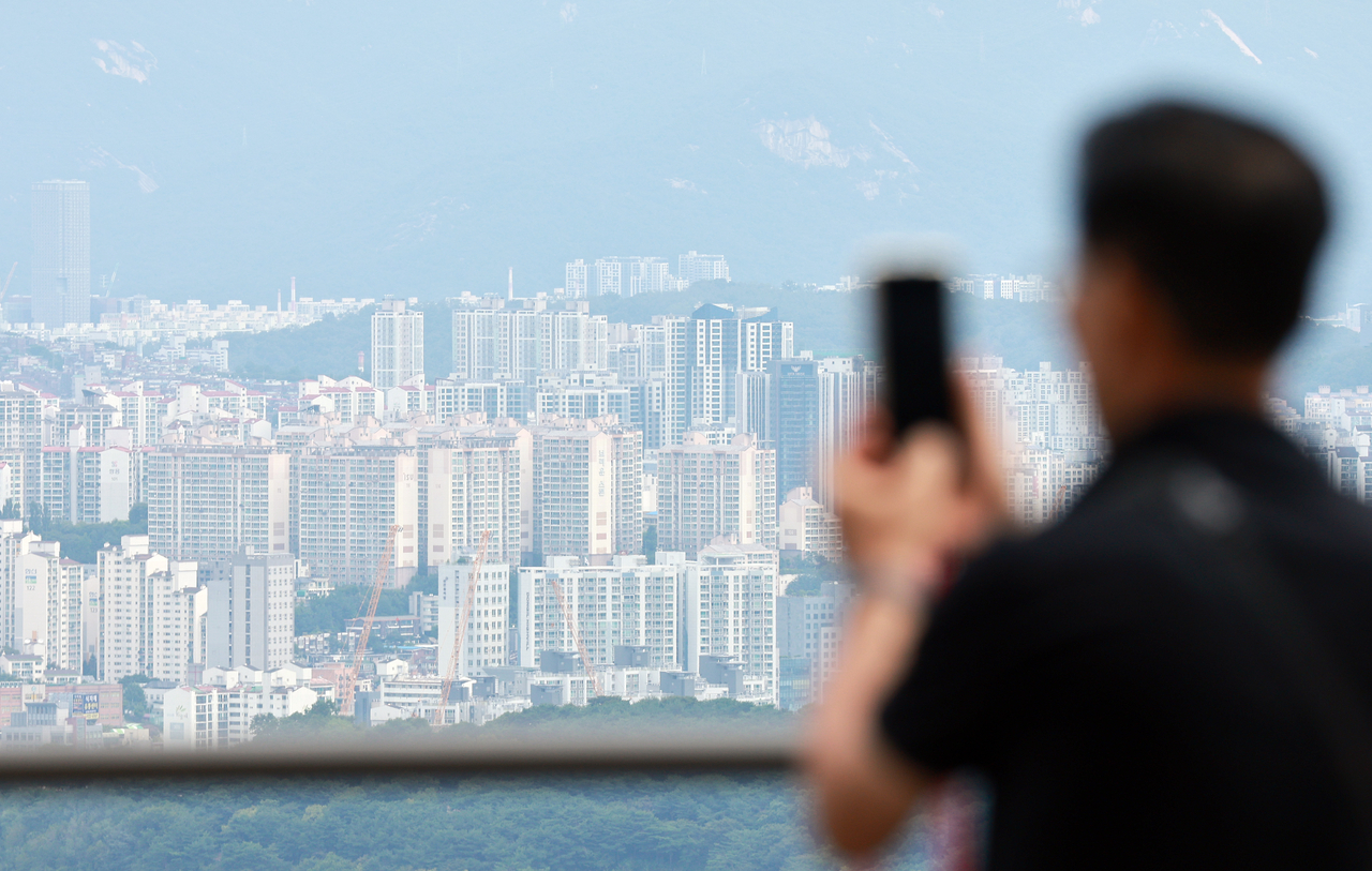 Apartment buildings can be seen across the river from N Seoul Tower on Sunday. (Yonhap)