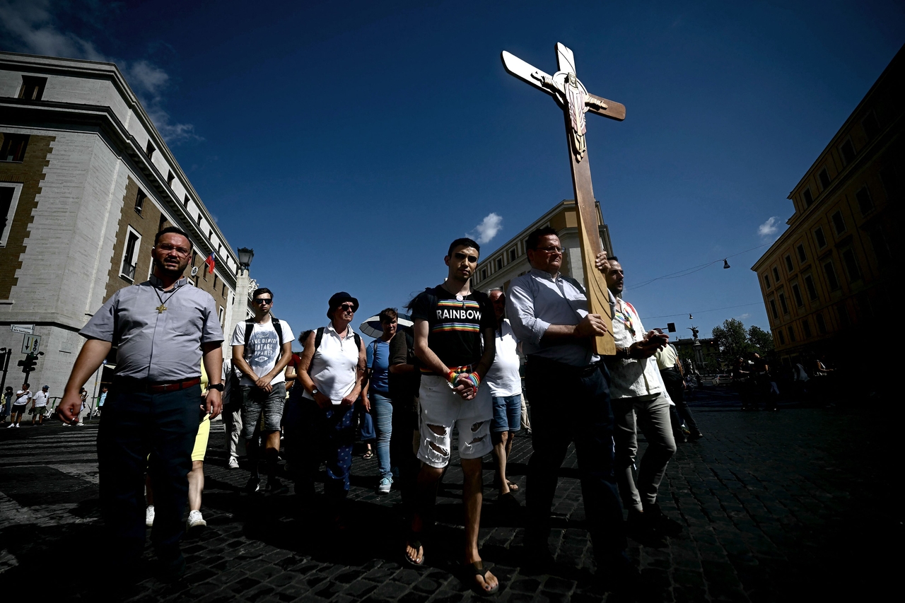 Pilgrims march to pass the holy door of St. Peter's basilica during the LGTBQ jubilee, at the Vatican, on Saturday.    (AFP-Yonhap)