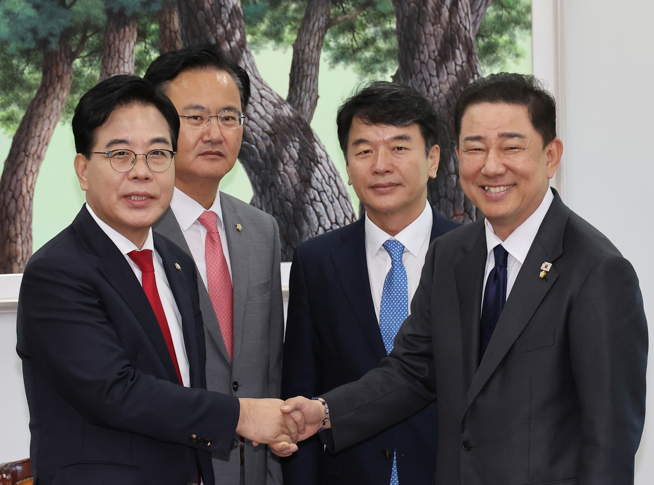 Democratic Party floor leader Kim Byung-ki (first from right) and People Power Party floor leader Song Eon-seok (first from left) shake hands after a meeting on Wendesday at the National Assembly in Yeouido, Seoul. (Yonhap)