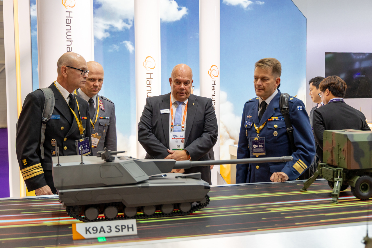 Military officials review Hanwha's exhibition booth at the Defence and Security Equipment International 2025 in London on Tuesday. (Hanwha Aerospace)