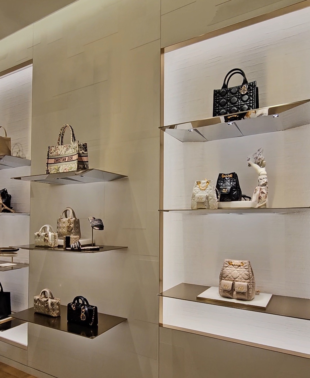 Luxury bags, from totes to small shoulder bags, are on display inside a Dior store at a department store in Seoul, on Monday. (Choi Jae-hee / The Korea Herald)