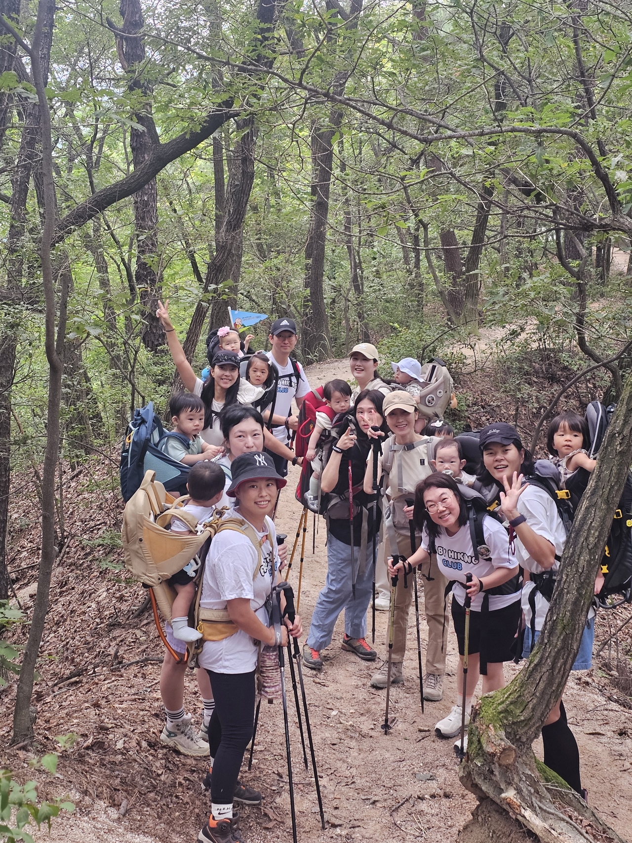 The Baby Hiking Club pauses midhike to pose for a photo (Choi Jae-hee/The Korea Herald)