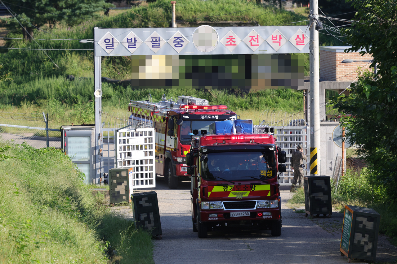 Firefighters and emergency personnel enter an Army base in Paju, Gyeonggi Province, following reports of an explosion on Wednesday. Yonhap