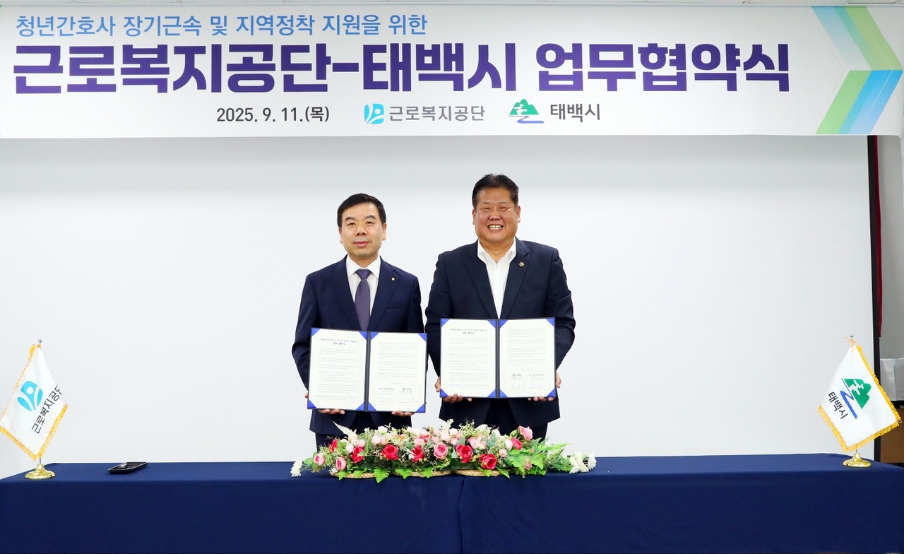 박종길 근로복지공단 이사장(왼쪽)과 이상호 태백시장(오른쪽)이 11일 공단 태백병원에서 청년간호사 장기근속 및 지역정착을 위한 업무협약을 체결 후 기념사진을 촬영하고 있다. [근로복지공단 제공]