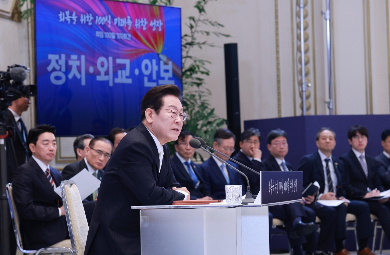 President Lee Jae Myung (front) speaks at a press conference marking 100 days in office, at the former presidential compound Cheong Wa Dae in Seoul on Thursday. (Pool photo by Yonhap)