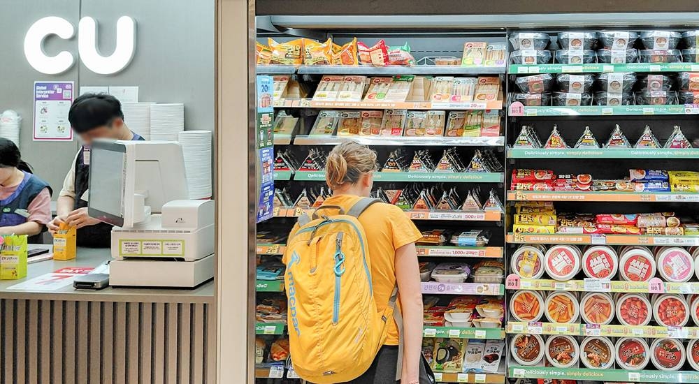 A customer browses gimbap displayed at a CU convenience store in Myeong-dong, central Seoul. (BGF Retail)