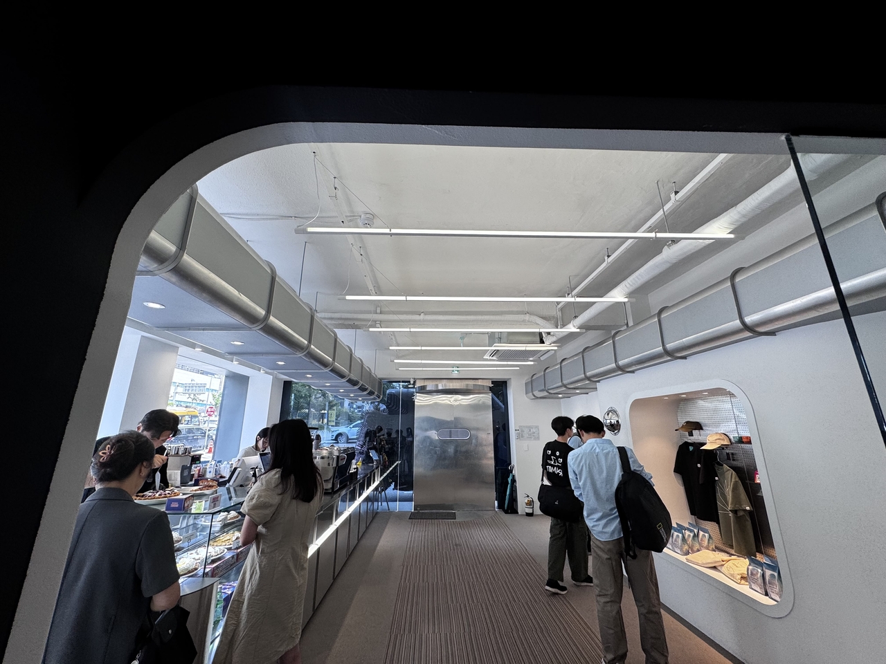 The first floor of Cafe Curious features a coffee counter and a small merchandise display near the entrance. (Moon Joon-hyun/The Korea Herald)