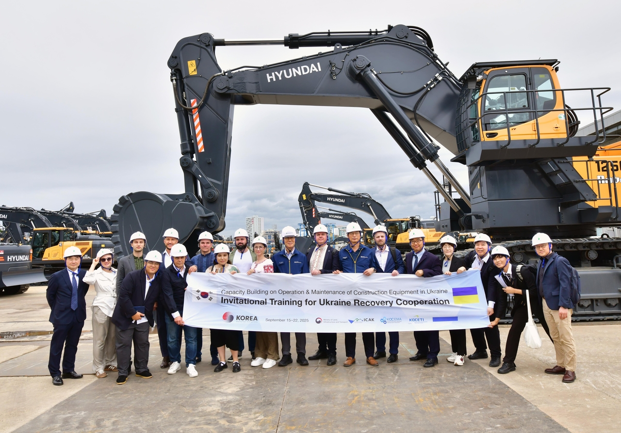 HD Hyundai Construction Equipment CEO Choi Cheol-gon (first row, fifth from left), Marina Denysiuk (first row, fourth from left), deputy minister of Ukraine’s Ministry for Development of Communities, along with company executives and Ukrainian government officials, pose for a photo on Thursday after participating in the Construction Machinery Capacity-Building Training Program. (HD Hyundai XiteSolution)