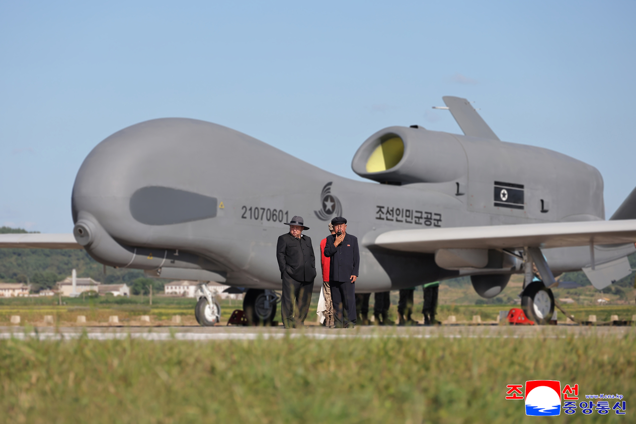 This photo, carried by North Korea's official Korean Central News Agency, shows the North's leader Kim Jong-un overseeing a performance test of tactical attack drones and other unmanned aerial vehicles on Thursday. (Yonhap)