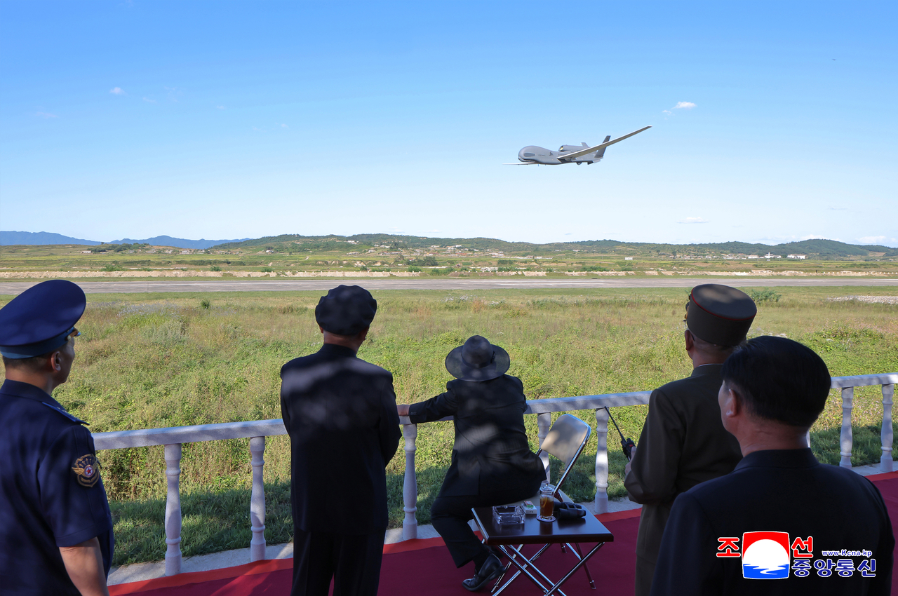 This photo, carried by North Korea's official Korean Central News Agency, shows the North's leader Kim Jong-un overseeing a performance test of tactical attack drones and other unmanned aerial vehicles on Thursday. (Yonhap)