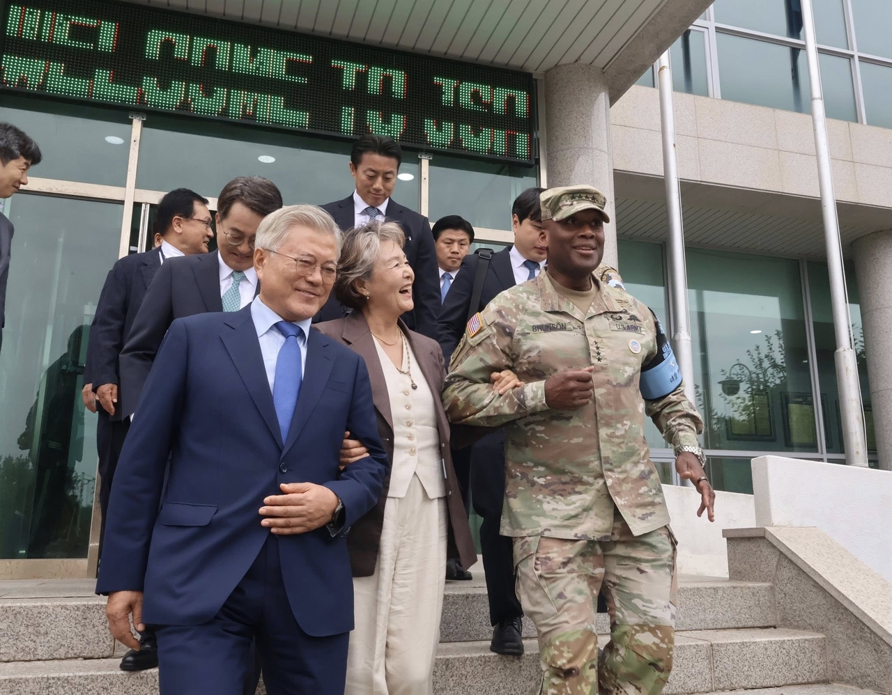 Former President Moon Jae-in walks down the stairs with US Forces Korea Commander Gen. Xavier Brunson during Moon's visit to the Joint Security Area on Sept. 19, 2025. (Yonhap)