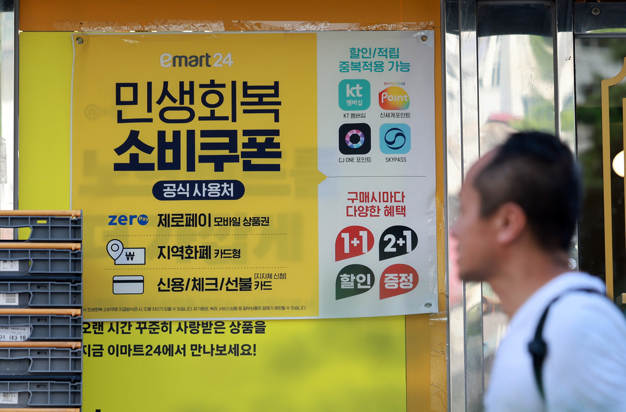 A sign on a convenience store window in Seoul on July 22 shows the shop accepts stimulus spending coupons. (Newsis)