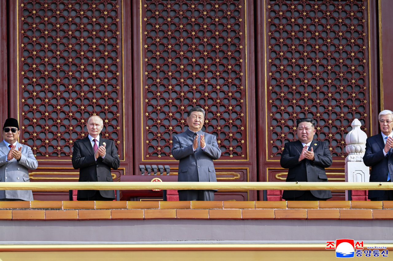 This is a photo taken by the Korean Central News Agency showing Putin, Xi Jinping, and Kim Jong-un standing in a row at the ceremony in Beijing on Sep. 4 marking the 80th anniversary of China’s Victory Day. (Yonhap)
