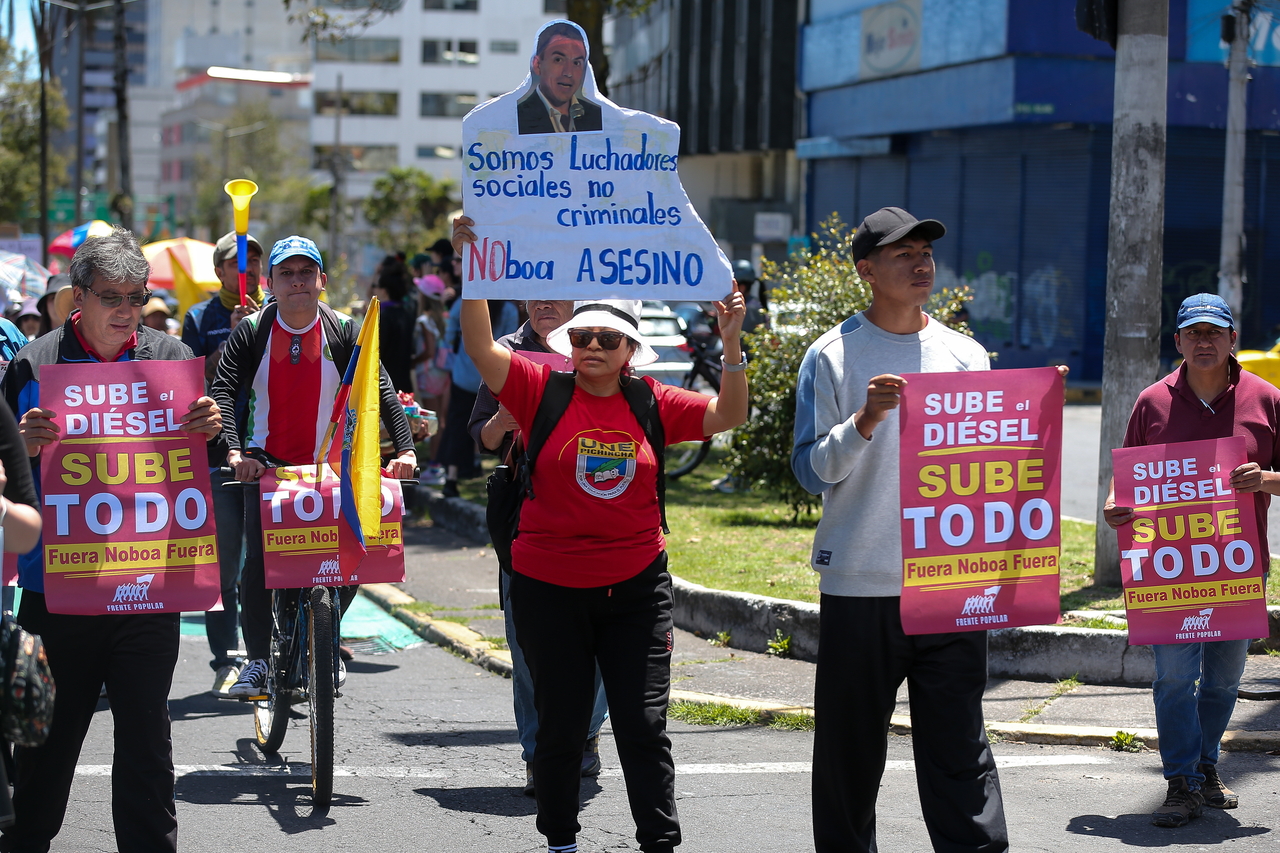 People hold signs during a demonstration in Quito, Ecuador, Sunday. (EPA-Yonhap)