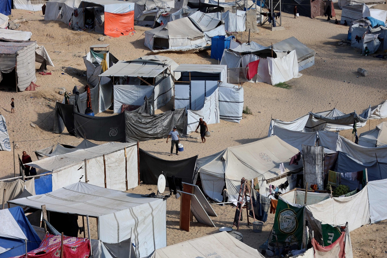 People go on with their lives at a camp for displaced Palestinians in Khan Younis in the southern Gaza Strip, Monday. (AFP-Yonhap)