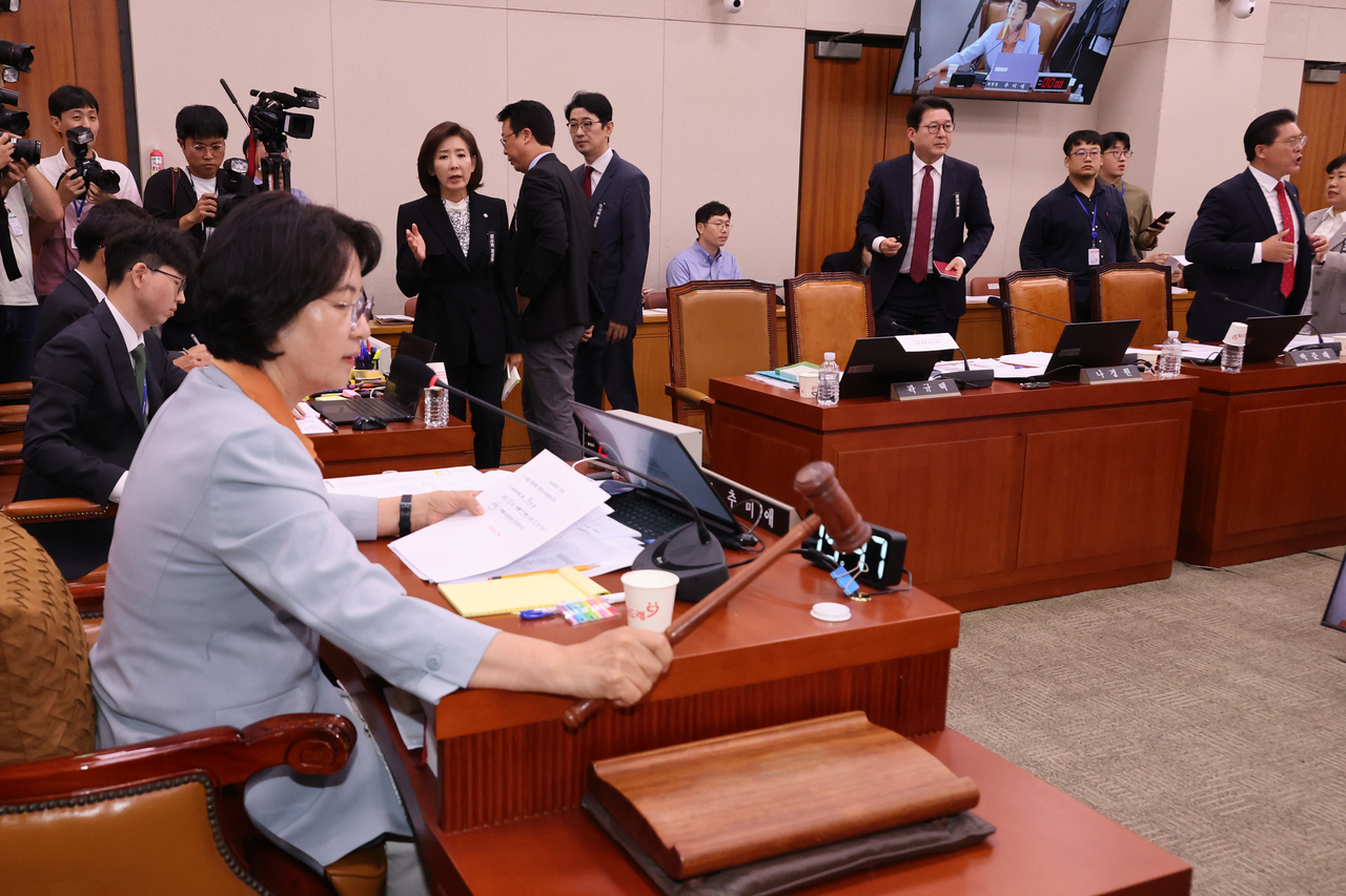 30일 국회 법제사법위원회 전체회의에서 더불어민주당 소속 추미애 위원장이 대법원에 대한 현장검증 실시계획서 채택의 건을 의결하며 의사봉을 두드리고 있다. 이에 반대하는 국민의힘 나경원 의원 등 위원들이 항의하며 회의장을 나가고 있다. [연합]