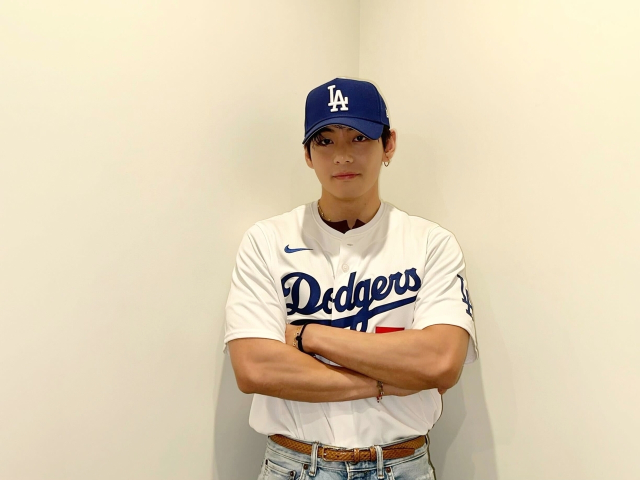 V of BTS poses before taking the mound to throw the ceremonial first pitch for the Dodgers in Los Angeles. (Big Hit Music)