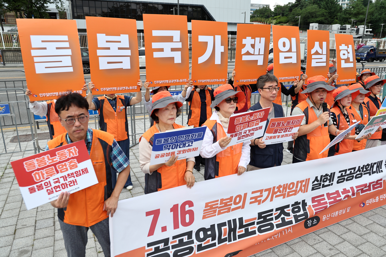 7월 2일 서울 전쟁기념관 앞에서 열린 ‘공공연대노동조합, 돌봄하루멈춤 선포 기자회견’에서 참석자들이 처우개선 등 관련 내용이 담긴 손 피켓을 들고 있다. [연합]