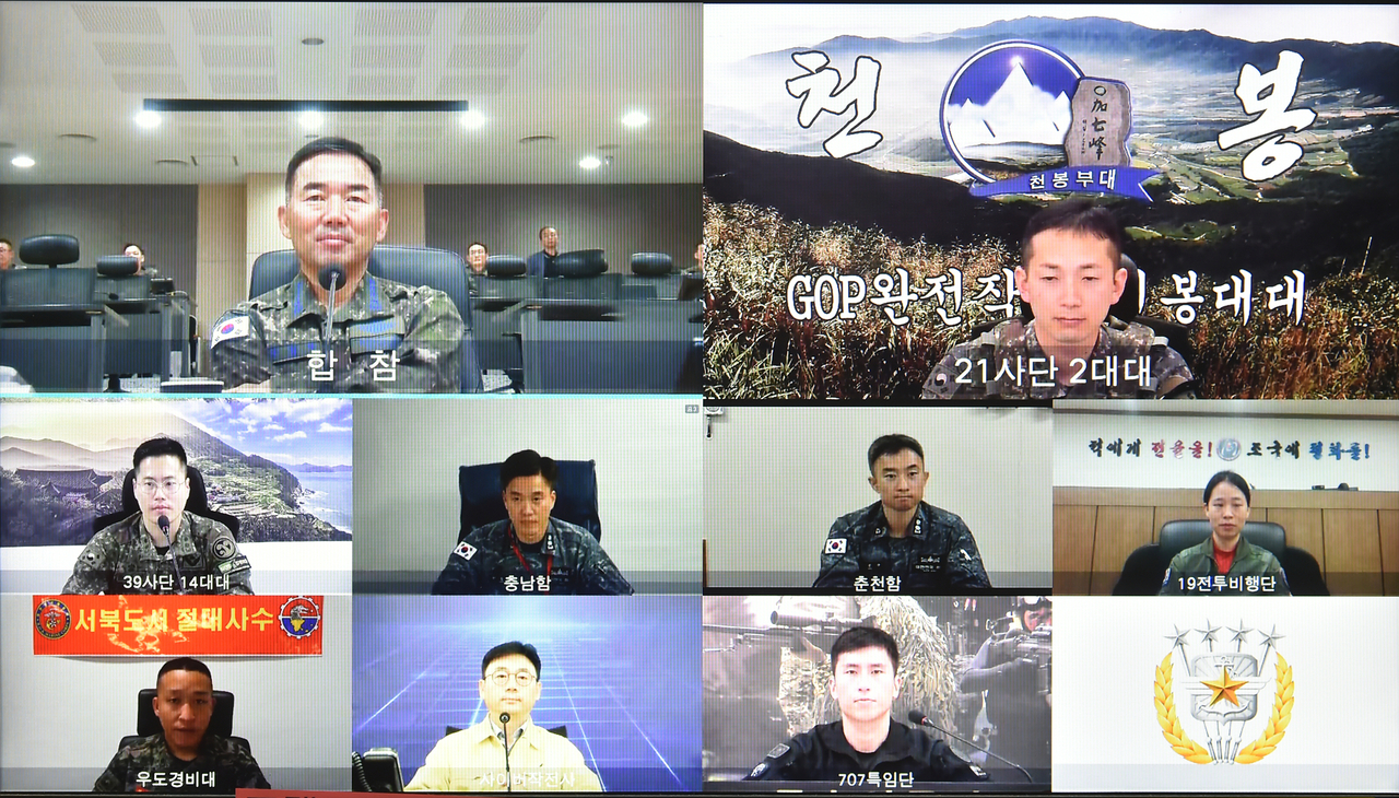 Gen. Jin Yong-sung, chairman of the Joint Chiefs of Staff, speaks via video call with troops and civilian personnel in charge of operations across land, sea, air and cyber domains, as well as counterterrorism response teams, on Monday. (JCS)