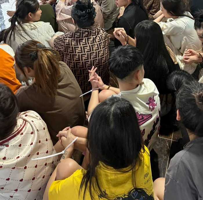 In this photo released by Agence Kampuchea Press (AKP), online scammers arrested by authorities are seen in a building in Sihanoukville province, southwestern of Phnom Penh, Cambodia, July 15. (AP)