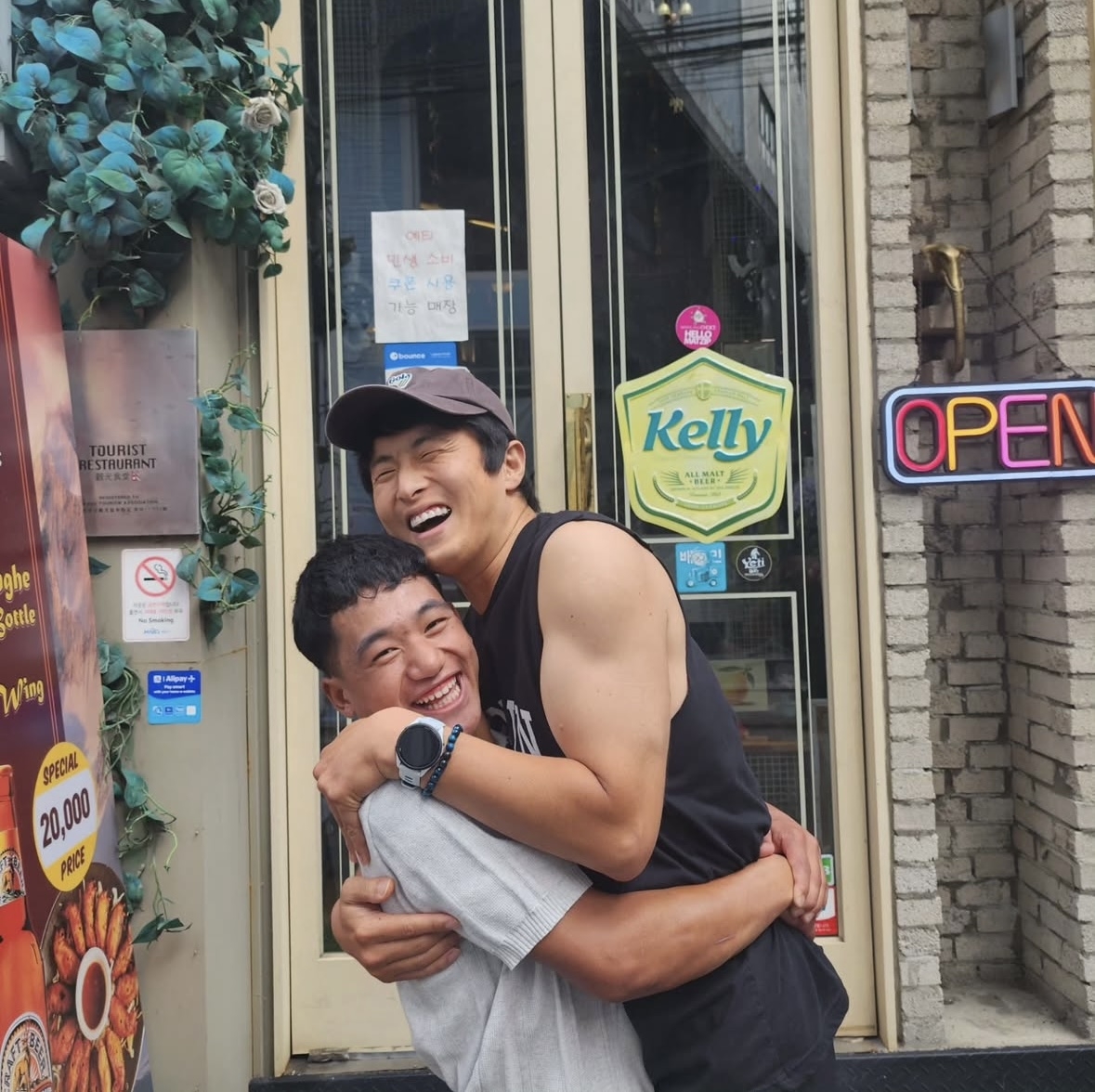 Tamang Nabin (left) shares an embrace with webtoon artist and TV personality Kian84 during his visit to Seoul in August. (Kian84's Instagram)