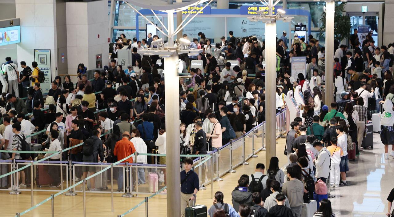 On Oct. 3, the first day of the Chuseok holiday, travelers line up for check-in at Incheon International Airport’s Terminal 1. (Yonhap)
