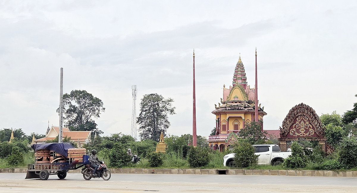 Vehicles drive along a road near Phnom Penh, the capital of Cambodia, on Tuesday. (Yonhap)