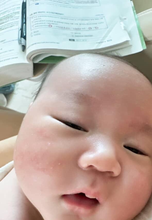 A test prep book is visible in this close-up shot of an 8-month-old boy, taken by his mother Lee who is preparing for the national civil servant exam. (Photo courtesy of Lee)