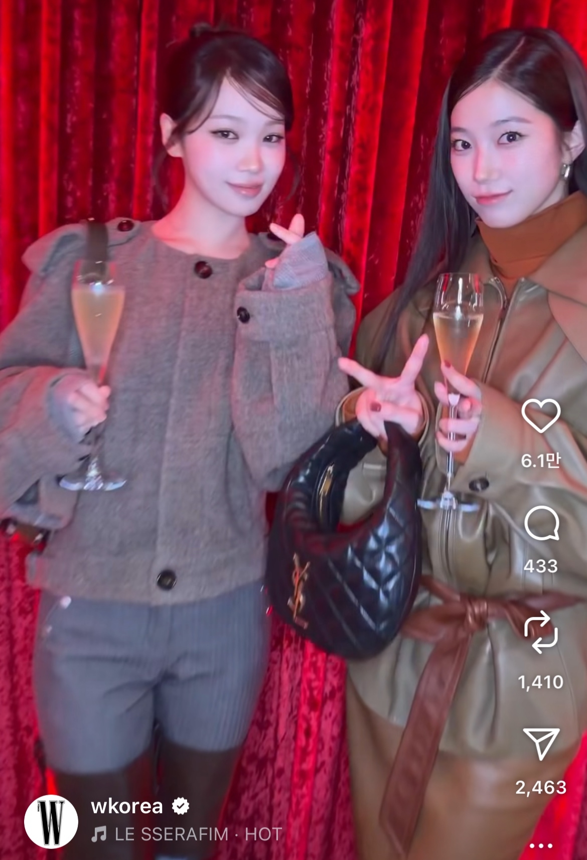 In this online video shared by W Korea, Le Sserafim members Kim Chaewon (left) and Kazuha pose with glasses of wine in their hands during the “Love Your W” event in Seoul, Wednesday. (W Korea's Instagram account)