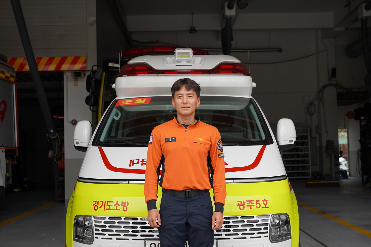 Firefighter Lee Hak-min poses in front of the Gwangju Fire Station. (Lee Si-jin/The Korea Herald)