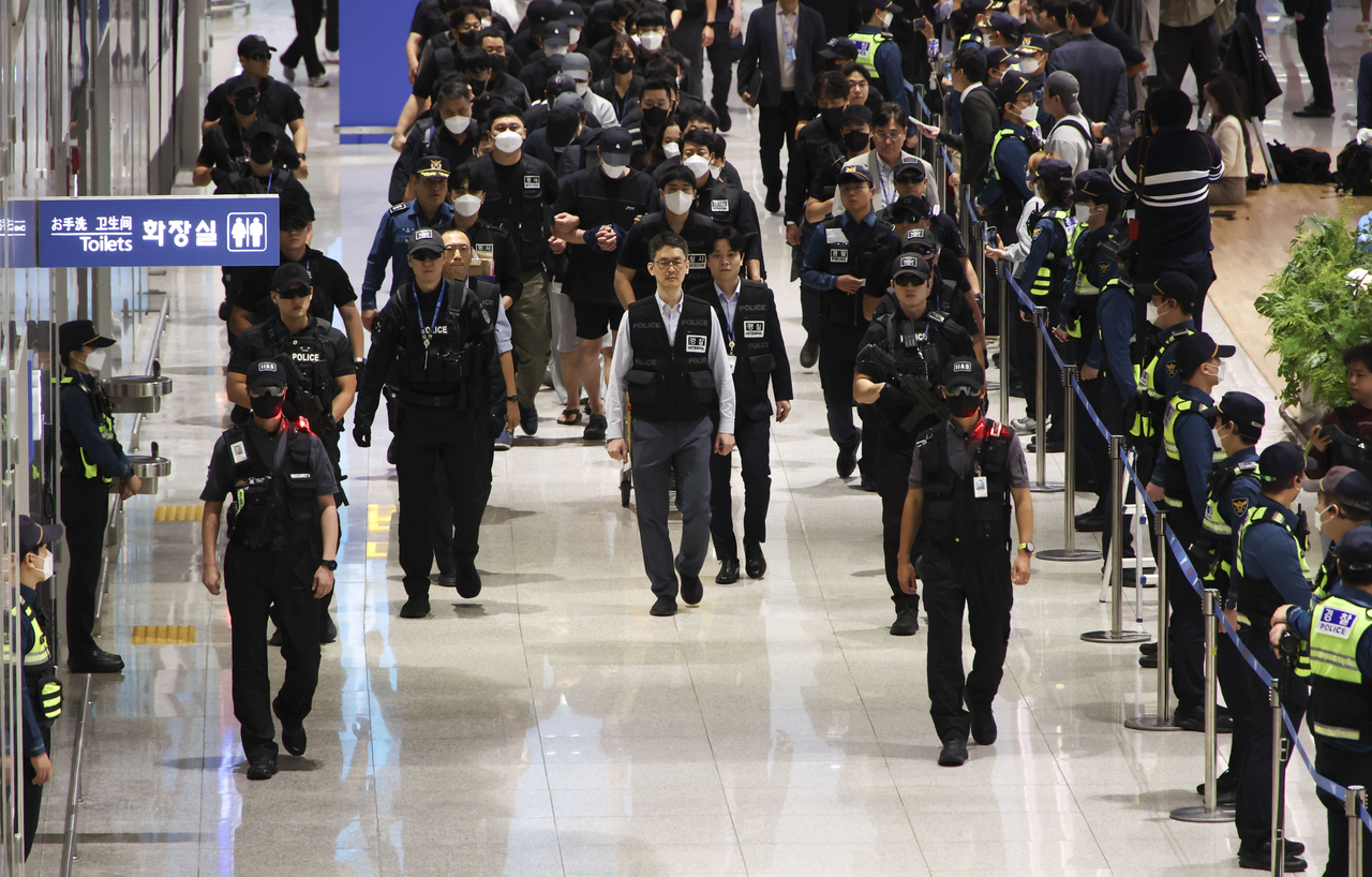 South Koreans detained in Cambodia for involvement in online scams are repatriated through Terminal 2 of Incheon International Airport on Saturday morning. (Yonhap)