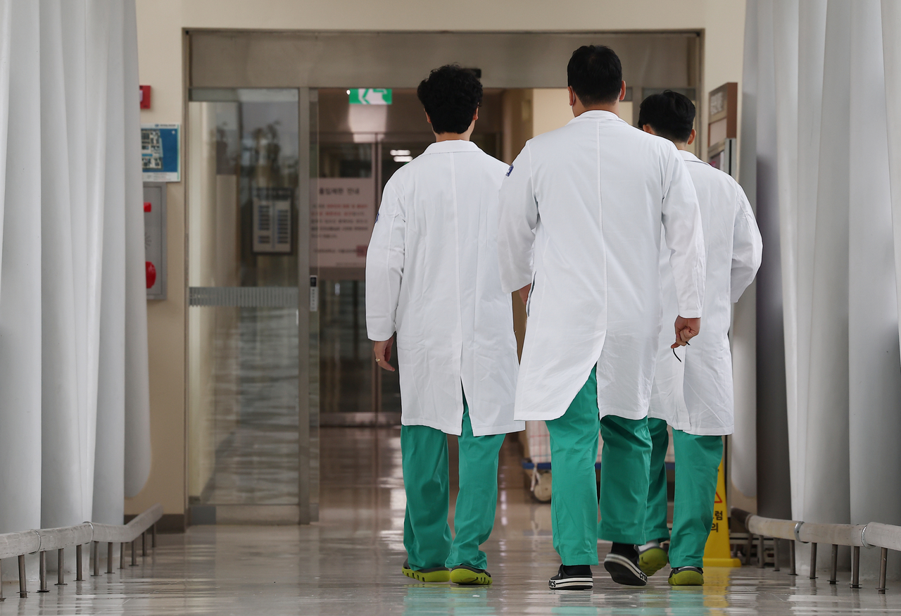Doctors walk the hallways of a university hospital in Seoul. (Yonhap)