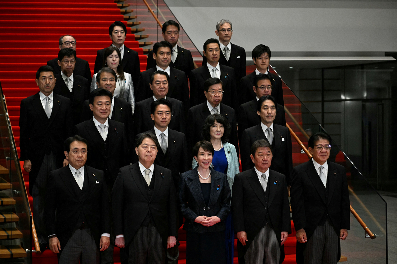 Japan's new Prime Minister Sanae Takaichi (center, first row) poses during a photo session with members of her cabinet at the prime minister's office in Tokyo, Tuesday. (Reuters-Yonhap)