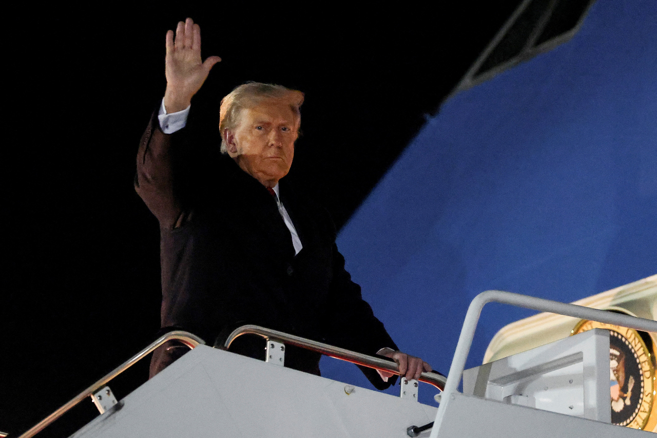 US President Donald Trump waves while boarding Air Force One as he departs for Asia, at Joint Base Andrews, Maryland, US, Friday. (Reuters-Yonhap)