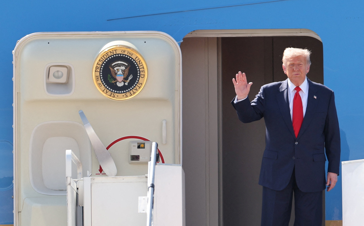 US President Donald Trump waves as he disembarks from Air Force One as he arrives at Kuala Lumpur International Airport to attend the 47th Association of Southeast Asian Nations Summit, in Kuala Lumpur, Malaysia, Sunday. (Reuters)